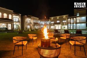 a fire pit in the middle of a yard at night at StayVista at Eleganza Villas & Resort, Jaipur in Jaipur