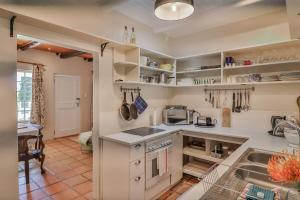 a kitchen with white cabinets and a sink at The Owl's Nest in McGregor