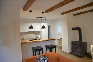 a kitchen and living room with a couch and a stove at Kuća za odmor Rubić in Vinkovci