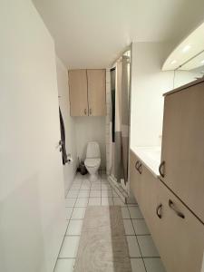 a white bathroom with a toilet and a sink at Cozy Pearl in Viborg Centre in Viborg +30 photos