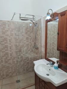 a bathroom with a sink and a mirror at Corte Crudili in Presicce