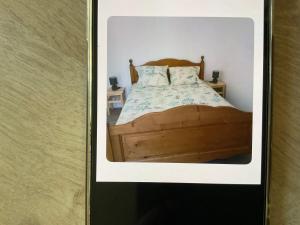 a picture of a bedroom with a wooden bed at Les cedres in Saint-Pierre-le-Moûtier