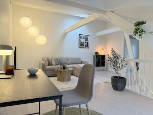 a living room with a couch and a table at Cozy Pearl in Viborg Centre in Viborg