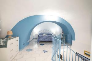 a bedroom with a blue and white room with a bed at Casa Zaffiro in Procida