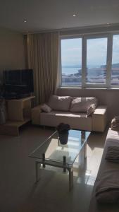 a living room with a couch and a glass table at Yana Privilege apartment Elinite in Elenite