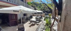 an outdoor patio with tables and chairs and an umbrella at Afouteza in Pontevedra