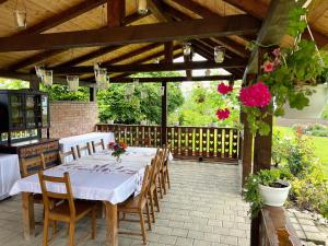 a patio with a table and chairs in a pavilion at Harvest House Transylvania 