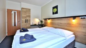 a bedroom with a large white bed with towels on it at Hotel Resort Luna in Ledeč nad Sázavou +35 photos