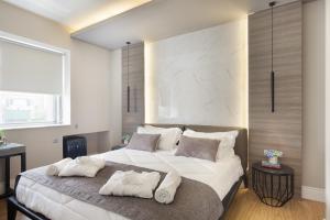 a bedroom with a bed and a dresser at 47 Luxury Suites in Athens