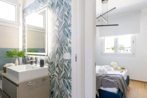 a bathroom with a sink and a mirror at Italian Experience - Brezza Costa Conero con Terrazza in Marcelli +33 photos