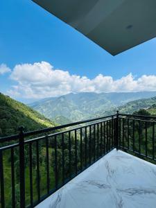 a balcony with a view of the mountains at Hotel Himalaya Heaven Khajjiar in Khajjiar  +19 photos