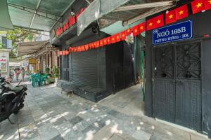 a building with a door and a sign on it at Old Quarter Art Boutique Family Suite Railside Respite in Hanoi