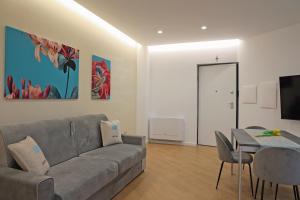 a living room with a couch and a table at PALAZZO NOVA luxury apartments in Acerra