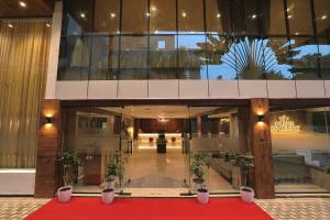 a large building with a red carpet in front of it at Hotel Grand Continent Premiere, Banjara Hills, Hyderabad in Hyderabad