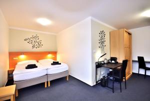 Postel nebo postele na pokoji v ubytování Hotel Resort Luna