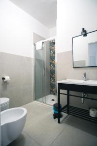 a bathroom with a sink and a toilet and a shower at Dal Monaco - casa verde in Castellana Grotte +15 photos