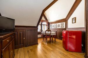 a living room with a red refrigerator and a table at Apartment 1925 in Palanga