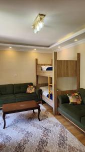 a living room with a couch and bunk beds at Trend Suite Hotel in Uzungöl