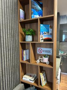 a wooden book shelf with books and books at West Point Luxury studio in Plovdiv