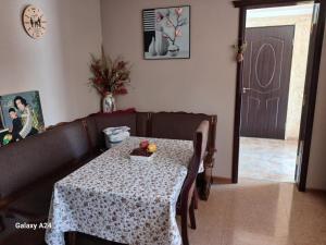 a living room with a table and a couch at Private family house in Kobuleti