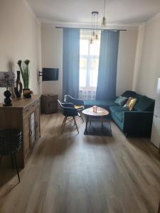 a living room with a couch and a table at Apartamenty MILANHOUSE in Gołdap