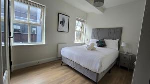 a bedroom with a bed and two windows at Galway City Centre, 3 bedroom, sleeps 6 in Galway