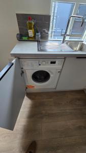a kitchen with a washing machine under a sink at Galway City Centre, 3 bedroom, sleeps 6 in Galway +8 photos