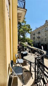 a balcony with a table and chairs on a building at BW Hostel in Belgrade +8 photos