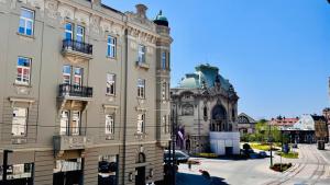 a large building in front of a building at BW Hostel in Belgrade