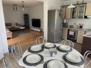 a kitchen with a table with plates on it at Vacation Home with Garden in Sînmartin