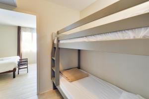A bed or beds in a room at Kyriad Perpignan Sud