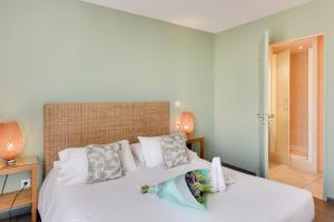 A bed or beds in a room at Kyriad Perpignan Sud
