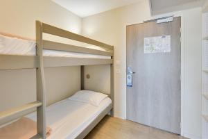 A bed or beds in a room at Kyriad Perpignan Sud