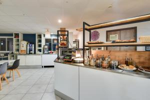 A kitchen or kitchenette at Kyriad Perpignan Sud
