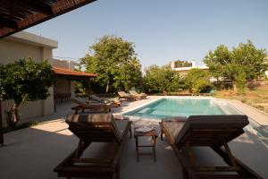 a patio with chairs and a swimming pool at Casa Alini in Ialysos