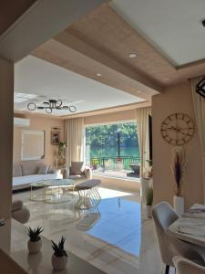 a living room with a clock on the wall at "Vista Paradiso" - Jaz - lake view in Višegrad