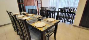 a dining room with a long table and chairs at A R villa and cottage in Gulmarg