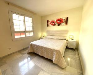 un dormitorio con una cama y una ventana en Expoholidays - Coqueto apartamento Puerto Deportivo, en Almerimar 4 fotos más