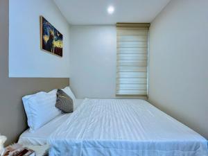 Postel nebo postele na pokoji v ubytování The Song Apartment 5 Stars Vung Tau - Căn Hộ The Sóng 5 Sao