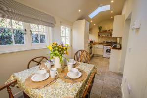 a dining room with a table and a kitchen at Craigendarroch No 2 in Acharn