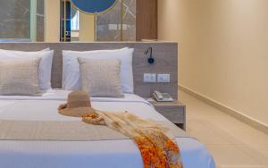 A bed or beds in a room at Three Corners Equinox Beach Resort
