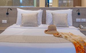 A bed or beds in a room at Three Corners Equinox Beach Resort