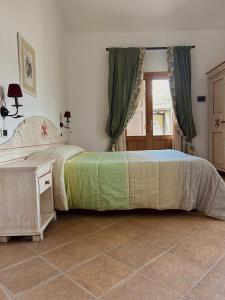 a bedroom with two beds and a tiled floor at Il Casale Mancini in Vada