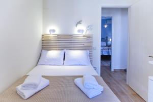 a bedroom with a bed with two towels on it at Amaryllis House Lefkada in Lefkada Town