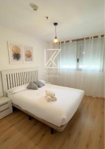 a bedroom with a large bed with white sheets at KOTA Zero Rivas Center 478 in Rivas-Vaciamadrid +24 photos
