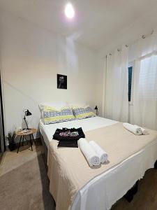 a white bedroom with a large bed with towels on it at Paradise found in Komiža