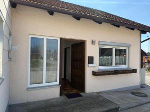 a small house with a door and two windows at Ferienwohnung Feßler in Steingaden +25 photos