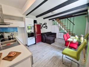 a kitchen and living room with a red refrigerator at Duplex Apartment Valter Strunjan in Strunjan +26 photos
