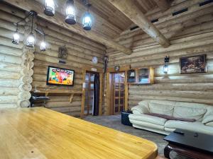 a living room with a table and a couch at Hotel Doi Haiduci in Orhei