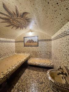 a tiled bathroom with a tub and a sink at Hotel Doi Haiduci in Orhei